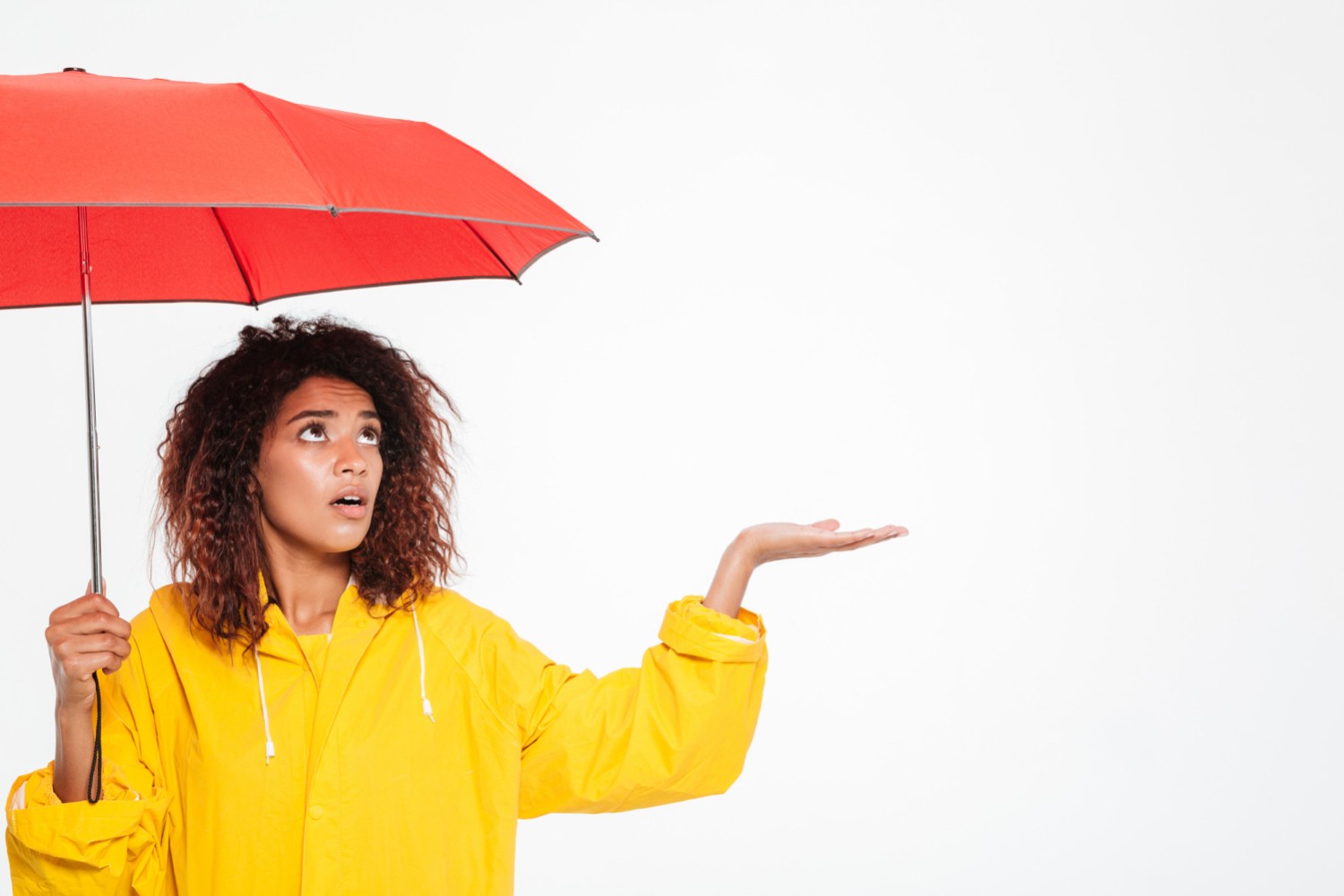 Waiting for the rain to stop. Woman in Raincoat White background. Человек прячется за плащом.